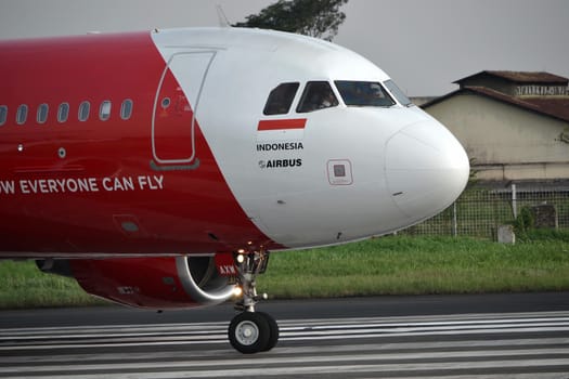 bandung, indonesia-june 16, 2014: Air Asia airplane taking manoeuvre on husein sastranegara airport bandung.