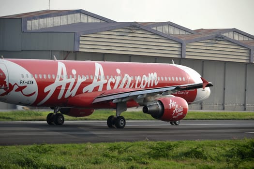 bandung, indonesia-june 16, 2014: Air Asia airplane taking manoeuvre on husein sastranegara airport bandung.
