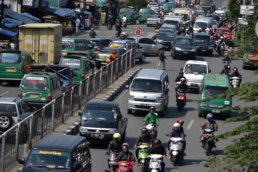 bandung, indonesia-june 16, 2014: scenery of busy traffic in bandung city, west java-indonesia.