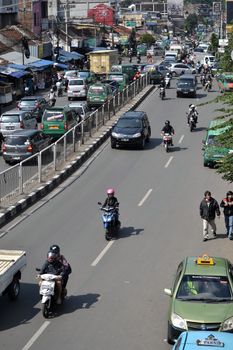 bandung, indonesia-june 16, 2014: scenery of busy traffic in bandung city, west java-indonesia.