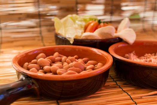 Set of three bowls with salad, beans and tuna