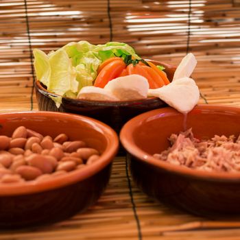 Set of three bowls with salad, beans and tuna