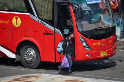 bandung, indonesia-june 16, 2014: bus parking at cicaheum bus station waiting for passenger to board.