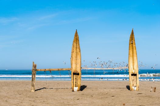 Traditional Peruvian small Reed Boats (Caballitos de Totora), straw boats still used by local fishermens in Peru