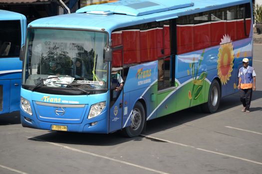 bandung, indonesia-june 16, 2014: bus parking at cicaheum bus station waiting for passenger to board.