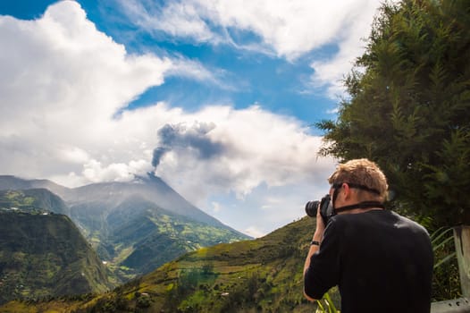 BANOS, DECEMBER 10: Unrecognizable brave photographer  in a gas mask takes pictures of Tungurahua volcanic eruption - december 10, 2010 in Banos, Cordillera Occidental of the Andes of central Ecuador, South America 