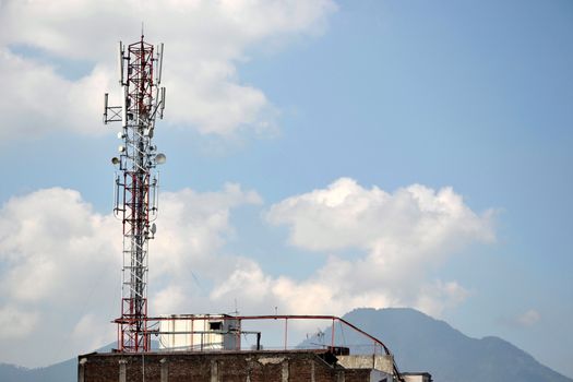 typical communication tower in telecommunication industry againts blue sky