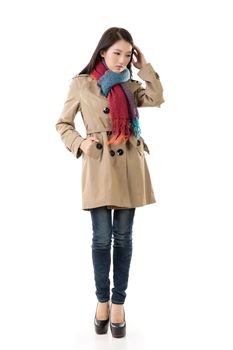 Attractive Asian lady with coat in winter, full length portrait isolated on white background.