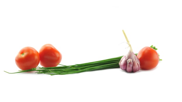 Mediterranean food ingredients: spring onions, garlic and tomatoes