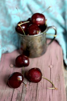 Sweet cherry in the ancient pewter mug 