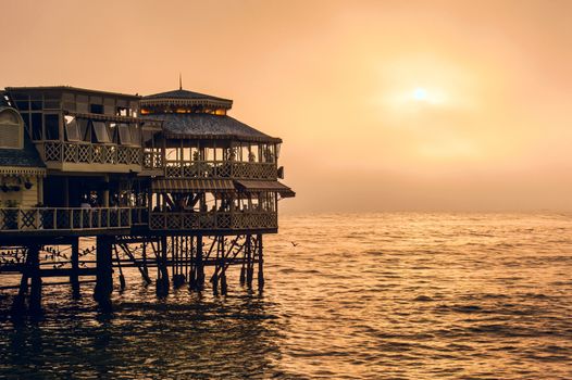 Evening Lima. Sunset on the Pacific Ocean, the sun breaks through the mist. Peru, Latin America