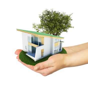 Hands holding a small house with land. Isolated on white background