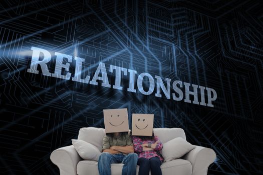 The word relationship and silly employees with arms folded wearing boxes on their heads against futuristic black and blue background