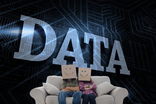The word data and silly employees with arms folded wearing boxes on their heads against futuristic black and blue background