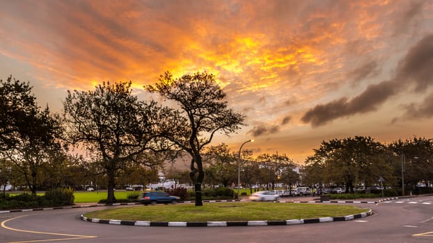 A small roundabout overlooking the mountains in the city of Stellenbosch, South Africa during a warm glowing sunset