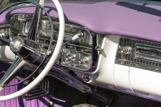 dashboard and steering wheel on a classic car, circa 1950