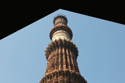 looking through qutub minar in blue sky