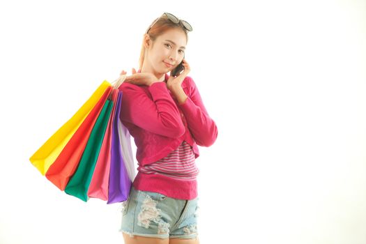 Shopping young asian woman talking on the phone looking happy isolated on white background
