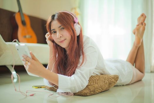 Young asian beautiful woman with smart phone and listening to music