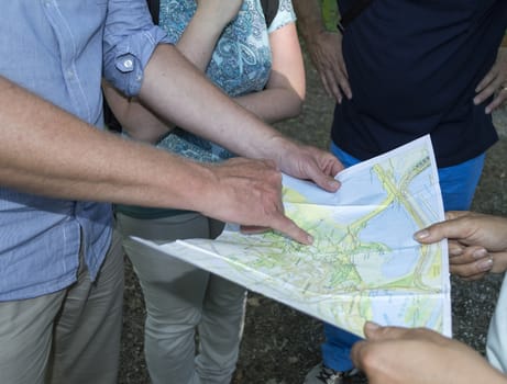 people looking on the map for the destination for walking