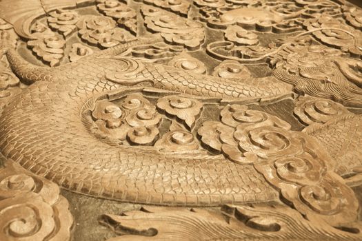 Close up of wood carving of a dragon
