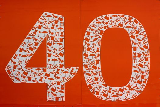 On an orange background number forty in which white icons of clothing, footwear, haberdashery