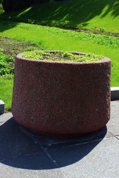 on a green vase outdoor beds with beautiful flowers