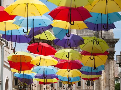 a lot of open multicolored umbrellas, street decoration, Pula, Croatia