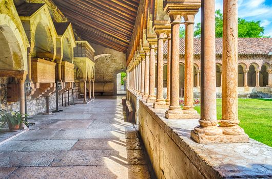 Cloister of San Zeno Cathedral in Verona showing ornate arches and carvings