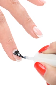 manicure applying, brushing fingernails with clear enamel