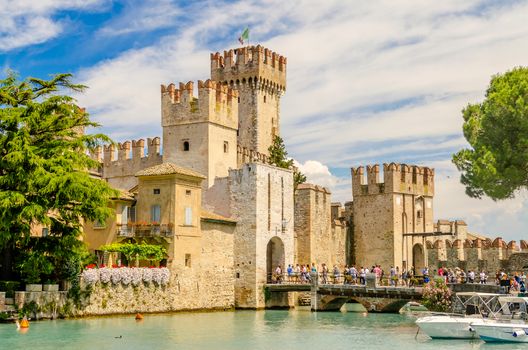 SIRMIONE, ITALY - JUNE 1, 2014: The Scaliger Castle in Sirmione, Italy, June 1, 2014. Surrounded by the water, the Scaliger Castle is considered one of the finest examples of medieval fortification.