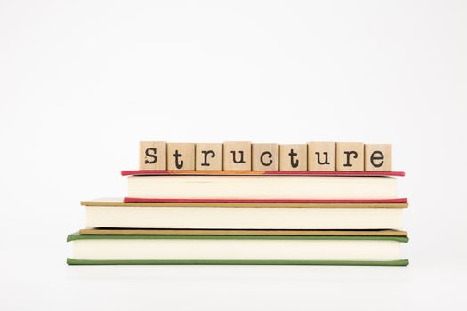 structure word on wood stamps stack on books