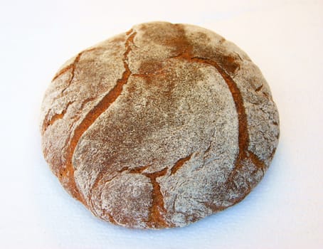 Long loaf of bread on white background is insulated