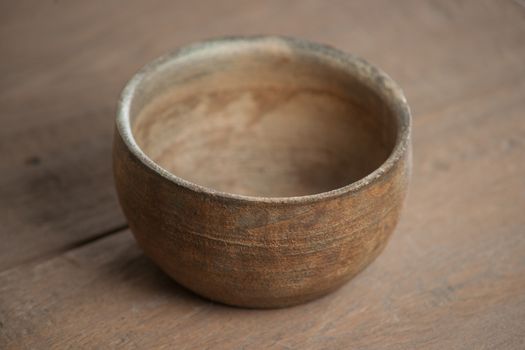 Traditional handcrafted dish of brown color on the table