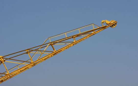 Yellow crane high in the blue sky