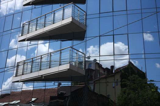 Reflection of old hauses and sky in the modern glass huose in Belgrade,Serbia