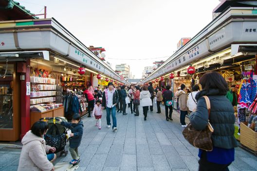 TOKYO, JAPAN - NOVEMBER 21 : Nakamise shopping street in Asakusa, Tokyo on 21 November 2013. The busy arcade connects Senso-ji Temple to it's outer gate Kaminarimon, which can just be seen in the distance. 