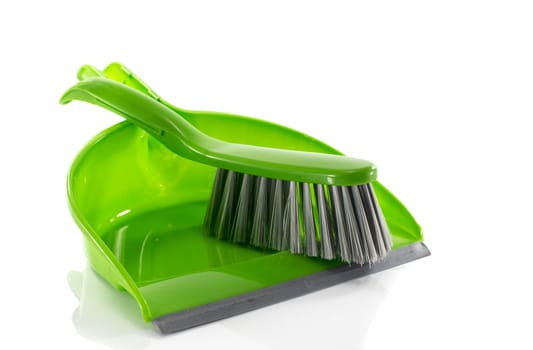 green dustpan and brush isolated on white