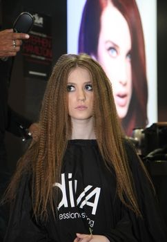 Model showing haircut and hair after special treatment at 23th iinternational fair and congress of cosmetics, solarium, equipment, wellness, spa and hair care, the largest beauty fair in South-east Europe, The touch of Paris, 26th and 27th April 2014. Belgrade,Serbia