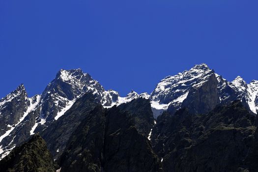 Caucasus mountains under snow and clear blue sky