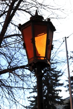 Retro street lamp shining at the twilight