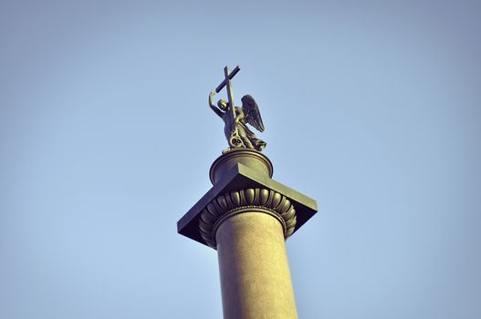 top of famous Alexander Column, showing statue of an angel holding a cross. Monument is placed on Palace Square of St.Petersburg