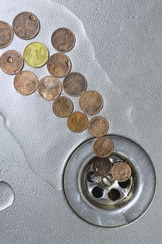 small Euro coins are cast-off and go to drain