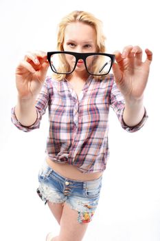Fashionable, sensual blonde girl in stylish glasses dressed in shirts and shorts