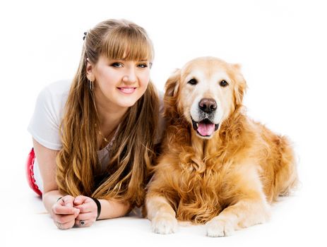 smiling girl with her ginger retriever looking into the camera