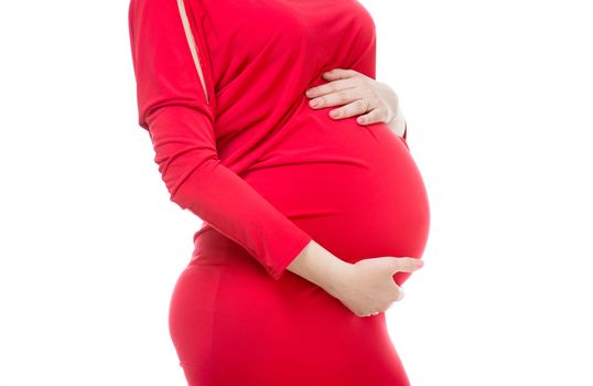 pregnant girl in a red dress hugging her belly on white background