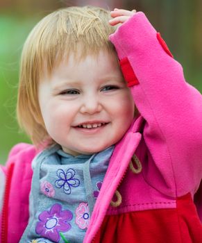 portrait of cute smiling little girl outdoors