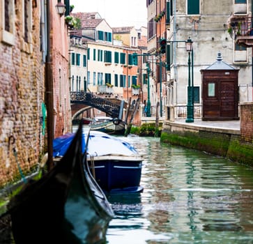 Beautiful Venetian water canal with boats and gondolas
