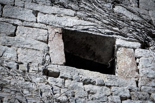 Old window on a abandoned stone house