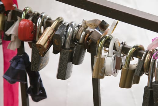 Wedding locks on the rail of a bridge